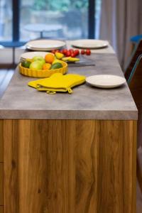 a table with a tray of fruit on top of it at Pine tree studio in St. St. Constantine and Helena