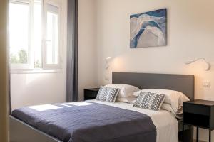a bedroom with a bed with two pillows on it at Podere n.8 Bio Casale Maremma in Alberese