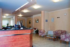 un vestíbulo con un bar con sillas y una mesa en Hotel Residence Vigone, en Vigone