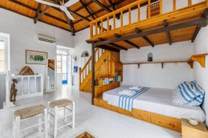 a bedroom with a bunk bed and wooden ceilings at The Lemon Tree House in Skopelos Town