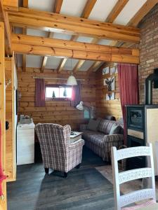 a living room with a couch and chairs in a cabin at Blockhaus an der Skiwiese Braunlage in Braunlage