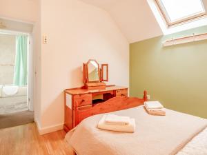 a bedroom with a bed and a mirror at The Granary - Uk43951 in Boosbeck