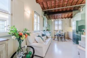 a living room with a white couch and a table at Helene Smart Flat with Elevator inside Lucca in Lucca