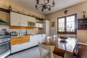 a kitchen with a table with a bowl of fruit on it at Villa Romantica Sea View in Camaiore