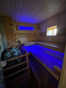 a swimming pool with blue lights in a room at Small Red-Brick House in Kaunas