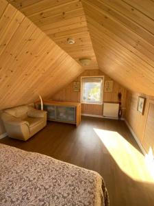 a bedroom with a bed and a chair in a room at Small Red-Brick House in Kaunas