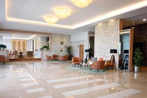 a lobby with chairs and tables in a building at Park Apartments Dubai, an Edge By Rotana Hotel in Dubai
