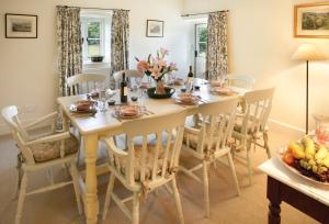 a dining room with a table and chairs at Ty Newydd in Tal-y-Cafn