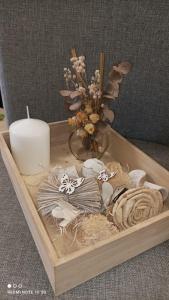 a wooden tray with a candle and a vase of flowers at casa roja marbella in Marbella