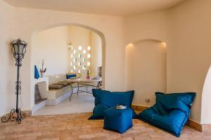 a living room with blue pillows and a table at Villa Canto dos Buzios in Carvoeiro