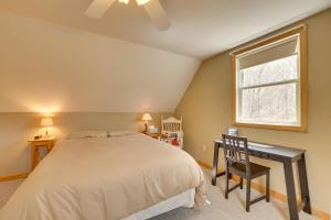a bedroom with a bed and a desk and a window at Spacious Jay Peak Vacation Rental with Mountain View in Jay