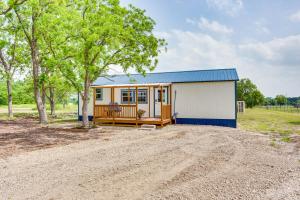 a small yellow and white shed with a porch at Northeast Texas Vacation Rental about 6 Mi to Commerce in Commerce