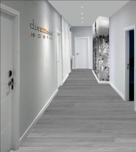 a hallway in a building with white walls and white floors at diezmadrid in Madrid