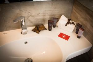 a sink with a faucet and other items on it at CASABONA1910 bed&breakfast in Vercelli