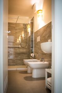 a bathroom with a sink and a toilet and a shower at CASABONA1910 bed&breakfast in Vercelli