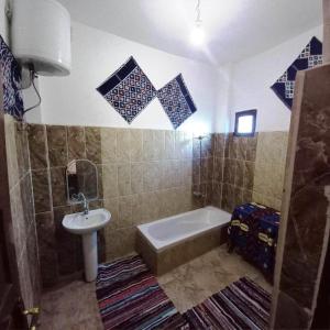 a bathroom with a tub and a sink and a bath tub at Julia View in Luxor