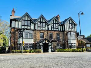 a large black and white building on the corner of a street at The Diamond Inn in Ponteland