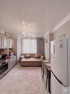 a living room with a couch and a refrigerator at RentHouse Apartments Premium Living in Chişinău