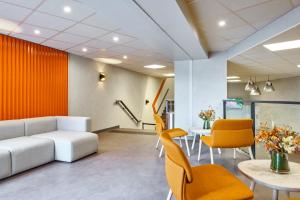 an office with a couch and chairs and a table at ibis budget Paris Porte d'Aubervilliers in Aubervilliers