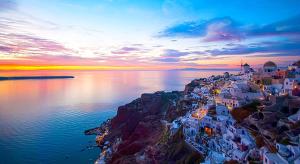 an aerial view of a town on the water at Maraki's Little House Santorini in Kamari