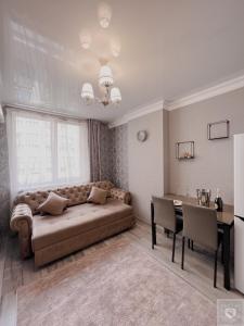 a living room with a large couch and a table at RentHouse Apartments Premium Living in Chişinău