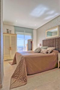 a bedroom with a large bed with a large window at Vida Mia Almeria - Superior Apartment in Vera