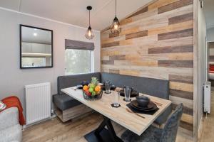 a dining room with a table with a bowl of fruit at Elite Holiday Caravan in Bassenthwaite