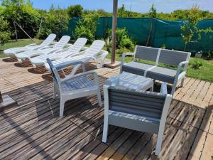 a group of chairs and tables on a deck at Els tarongers, perfect for families or friends in Sa Pobla