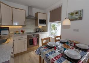 a kitchen with a table with a table cloth on it at Atlantic Retreat 10a Ventnor Terrace in St Ives