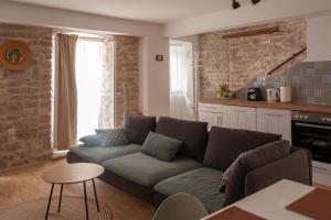 a living room with a couch and a table at Sketches of Milna in Milna