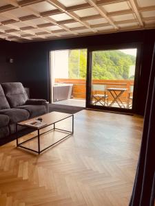 a living room with a couch and a coffee table at Private Spa Lodge Odenwald in Lindenfels