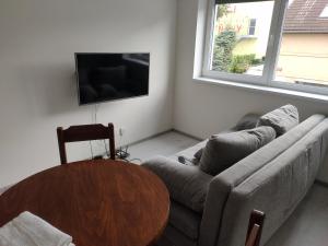 a living room with a couch and a table at Sun-House Pension - ParkingFree Limited spaces- in Prague