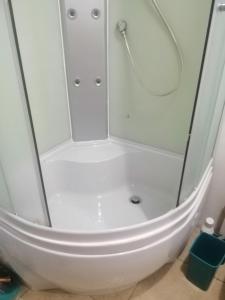 a shower with a glass door in a bathroom at В сердце города! Дерибасовская/Соборная площадь. in Odesa