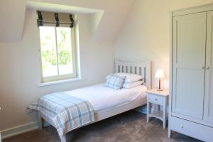 a small bedroom with a bed and a window at 4 bedroom holiday home with wheelchair accessible bathroom 2km from Kenmare in Kenmare