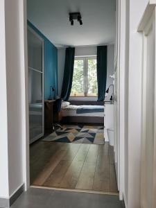 a bedroom with a bed and a window at Comfortable apartment close to the center and sea in Gdańsk