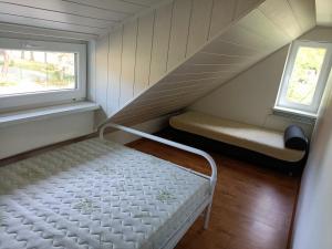 a small room with a bed and a window at Large apartment with parking in Palanga