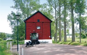 a red barn with tables and chairs in front of it at Stunning Home In Gränna With Lake View in Gränna