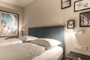 a bedroom with a bed with two pillows on it at Mali Apartments Lounge in Tirolo