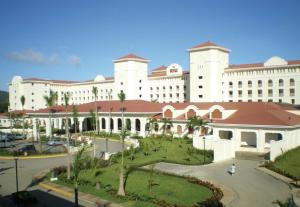 a large white building with a courtyard in front of it at Riu Guanacaste - All Inclusive in Coco