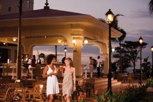 two women standing in front of a gazebo at Riu Guanacaste - All Inclusive in Coco