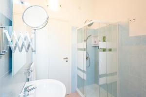 a bathroom with a shower and a sink and a mirror at Casa Mian - Bed and Breakfast in Orosei