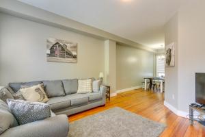 a living room with a couch and a table at Cozy Maryland Abode - Gas Grill, Near Devils Den! in Emmitsburg