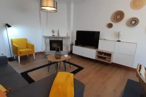 a living room with a couch and a television at Mar Doce Lar- Entre Mar e Ria in Gafanha da Nazaré