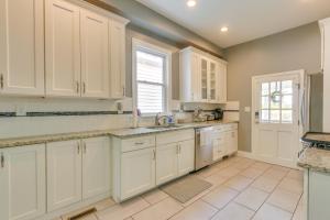 a kitchen with white cabinets and a sink at Cozy Maryland Abode - Gas Grill, Near Devils Den! in Emmitsburg