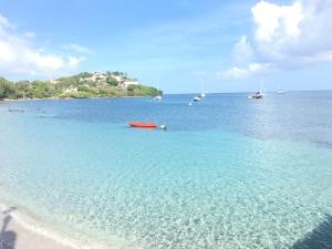 a view of a beach with boats in the water at Bungalow Matador Beach Breakfast OFFRE SPECIALE PONT DE MAI 1 NUIT OFFERTE in Les Trois-Îlets