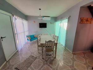 a dining room with a table and chairs at El Atardecer in Puerto Pirámides