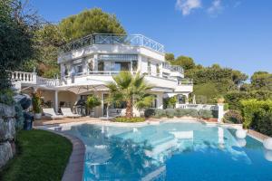 a large white mansion with a swimming pool at Luxury Villa with SPA in Golfe-Juan - Sea View in Vallauris