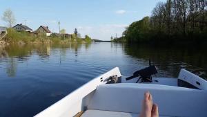 a person is sitting in a boat on a river at Camping: bring your tent or van in Feldkirchen bei Graz