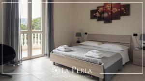 Postel nebo postele na pokoji v ubytování Residence La Perla