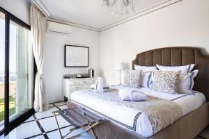 a bedroom with a large bed and a window at Luxury Villa with SPA in Golfe-Juan - Sea View in Vallauris +51 photos